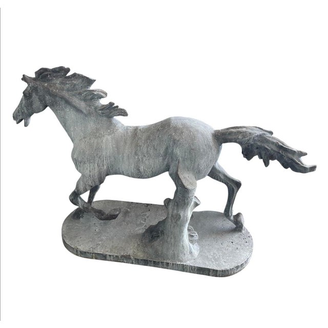 This striking vintage cast iron statue captures the raw power and fluid motion of a galloping horse. Rendered with...