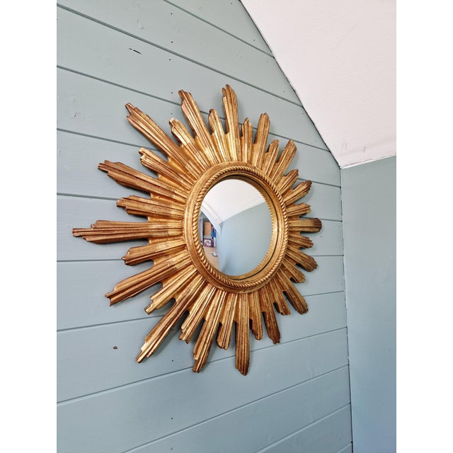 Gold-tone resin sunburst mirror with a convex mirror, dating from the late 1960s-70s. Very good condition. Diameter: 55 cm