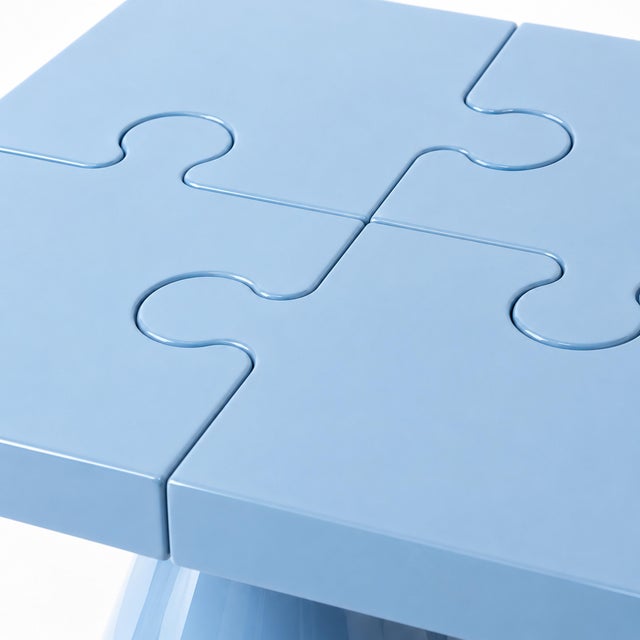 Popzlle turns a side table into a small piece of wit: its square top is cut into four interlocking puzzle pieces, finished...