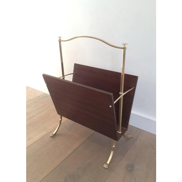 This nice magazine rack is made of mahogany and brass with claw feet. This is a French work byMaison Jansen, circa 1940.