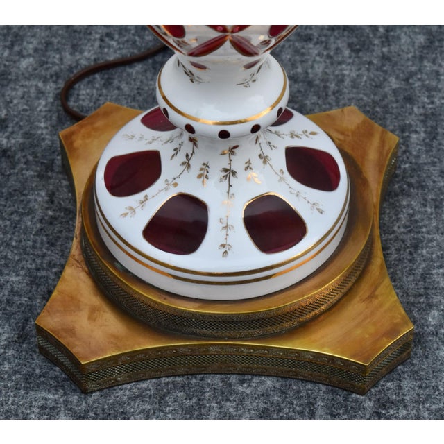 Vintage (1960's) Table Lamp has a Bohemian Style. White & Cranberry Glass Lamp Brass Base with Switch. The Measurements:...