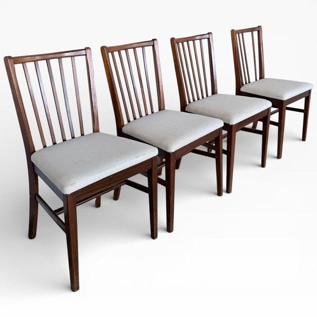 A stylish set of four mid century dining chairs by Morris of Glasgow, showcasing the brand’s understated craftsmanship and...
