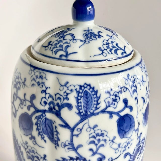An elegant vintage Chinese blue and white porcelain lidded jar, inspired by traditional Guan-style forms and painted in...