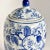 An elegant vintage Chinese blue and white porcelain lidded jar, inspired by traditional Guan-style forms and painted in...