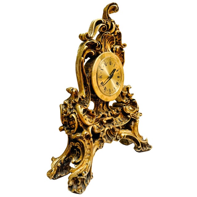 A dramatic, large scale mantle clock designed in the ornate Rococo Revival style and featuring sweeping C-scrolls,...