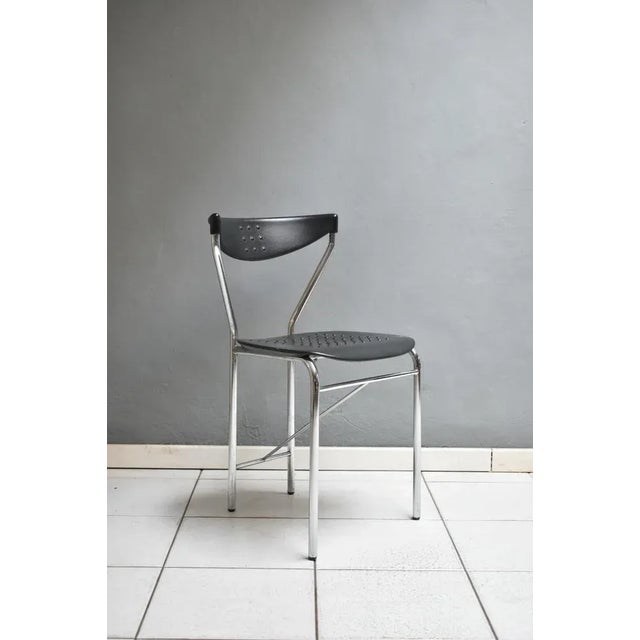 Set of four vintage 1980s, Italian manufacturing, Citterio Cucine design. The chairs have a steel structure with a black...