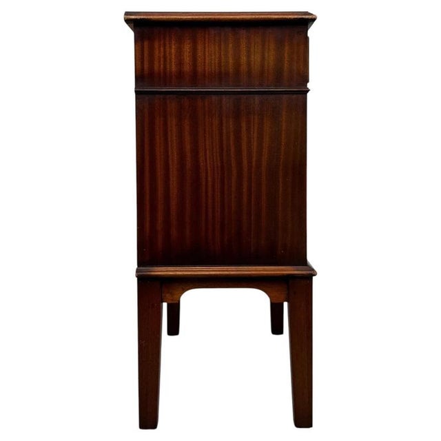 A charming and well-crafted 20th-century small cabinet, beautifully constructed in mahogany and combining practical...