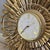 Mid-century Syroco Starburst wall clock, circa 1969. This stylish piece is made of cast plastic in an antique gold finish....