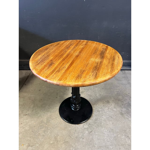 Vintage Cast iron and Wood Bistro Table. Circa 1960 Cast iron base with Flor de lie pattern and oak circular top.