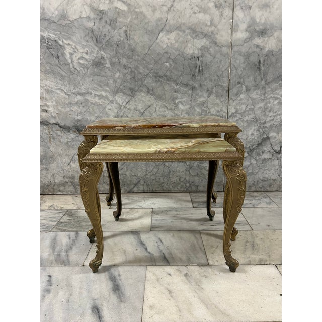 A pair of exquisite Victorian or Hollywood Regency style nesting tables. The onyx tops are removable and the bases are heavy.