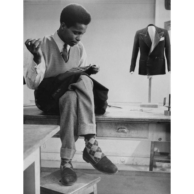 Women's American ORT Training School A young man sewing a piece of garment in a training and vocational school funded by...