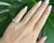 A rare and elegant Art Deco eternity band (circa 1930) crafted in platinum. The ring features a tapering design set with...