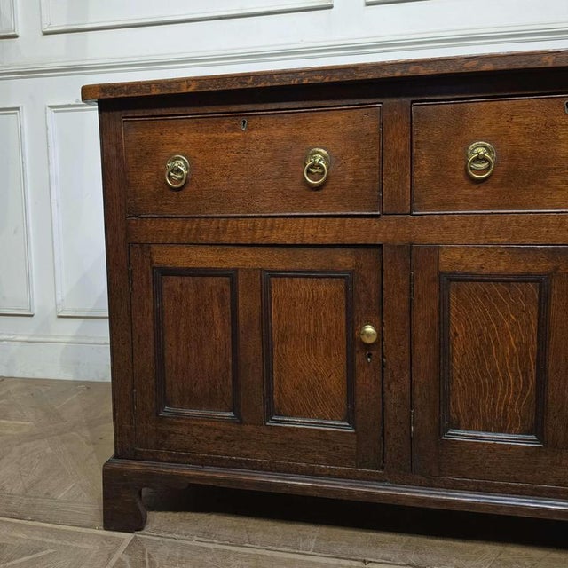 Wonderful early 19th C oak dresser base with good colour and lots of storage. 1820 This piece is designed in the style of...