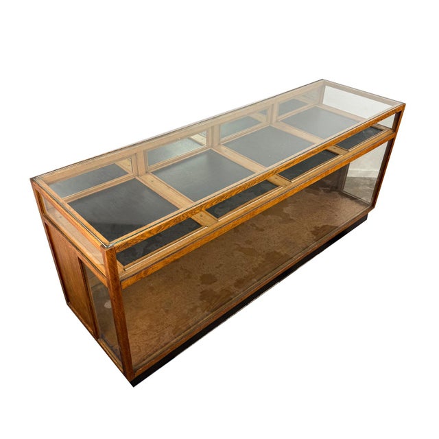 An impressive vintage oak shop display cabinet featuring a classic glass-fronted design and generous display space....