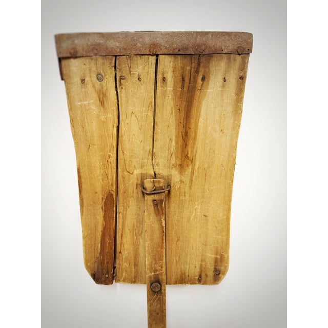 Hand-crafted from multiple boards of weathered wood, this substantial agricultural implement features an unusually long...