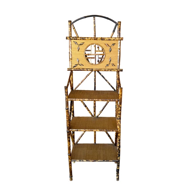 Beautifully crafted antique English spotted bamboo three tiered raised shelf. Shelves are made out of rattan wrapped wood...