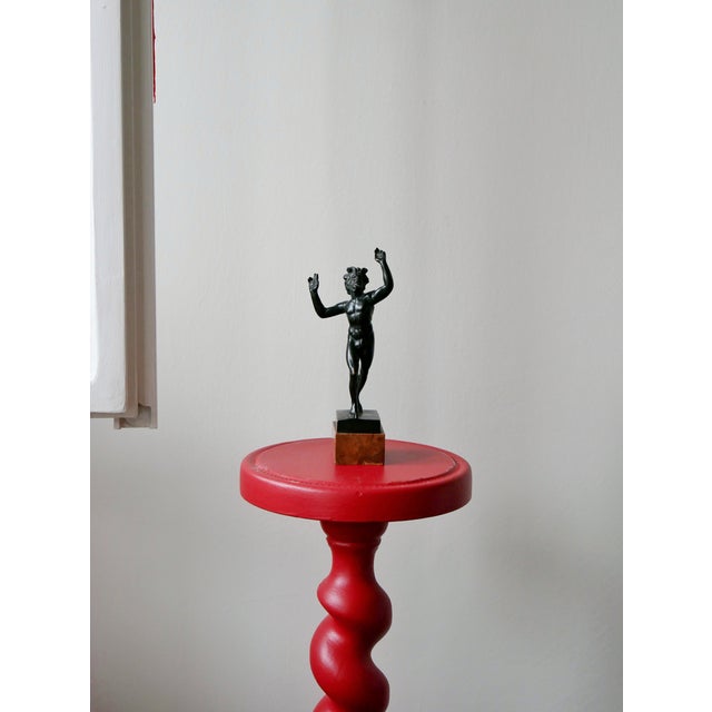 Beautiful antique sculpture made of bronze and marble. The sculpture is a small version of its original Faun of Pompeii.