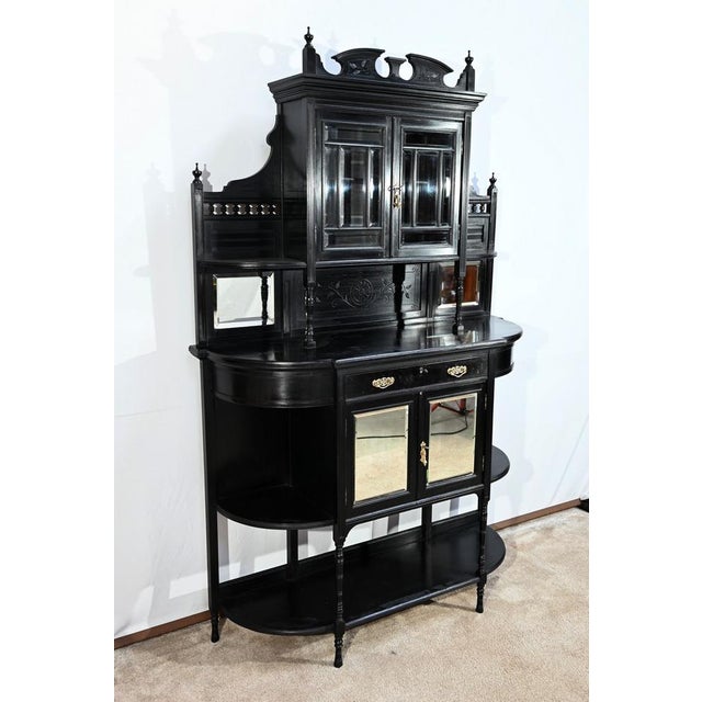 This blackened pear cabinet opens on a belt by a brass -drooping handle drawer. This drawer has a functional original lock...