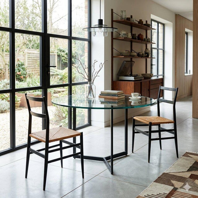 Chairs with enameled wood frames and rattan seats. There are signs of wear on the frame, and one seat has a crack. This...