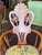Sweet Antique armchair from the Victorian era with carved detail on the arms and back, wheeled legs, arm shape curves...