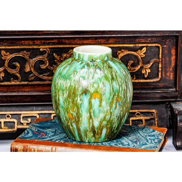 This striking handmade studio pottery vase is a true celebration of artisan craft, showcasing a mesmerizing, one-of-a-kind...