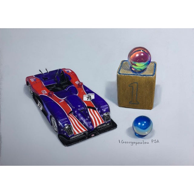 This artwork features a vividly rendered race car alongside two colorful marbles and a golden block marked with the number...