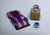 This artwork features a vividly rendered race car alongside two colorful marbles and a golden block marked with the number...
