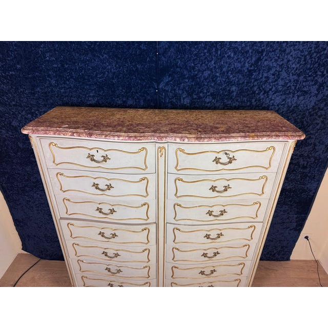 Weekly crossbow cabinet with double row of Louis XV style drawers in lacquered and gilded wood circa 1900 Opening on the...