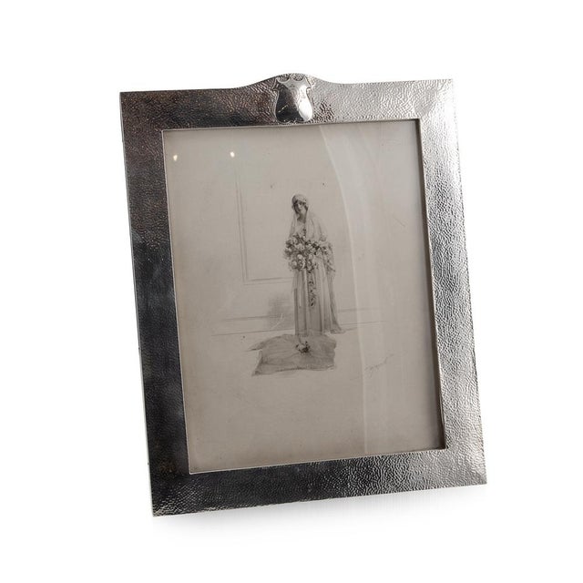 20th Century Arts & Crafts, hand hammered silver photograph frame, mounted on a leather bound easel support and set with...