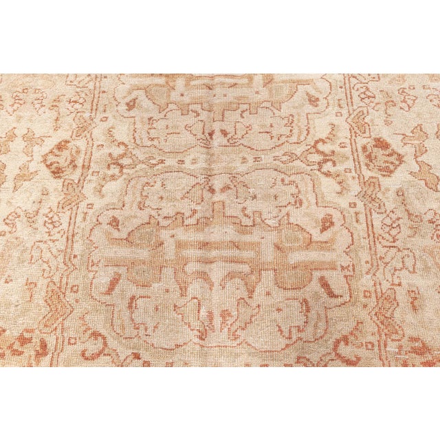 An early 20th century Indian Amritsar antique rug, the beige field with and irregular vertical geometric medallion...