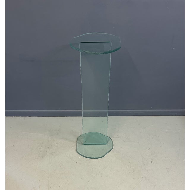 This 1990s Post Modern Rough Edge Glass Pedestal showcases a distinctive blend of rugged texture and refined form,...