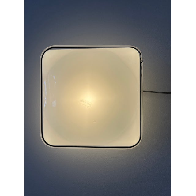 Vintage Italian wall light with a single square shade of milky white Murano glass with a black rim. Italy, 1960s Hand...