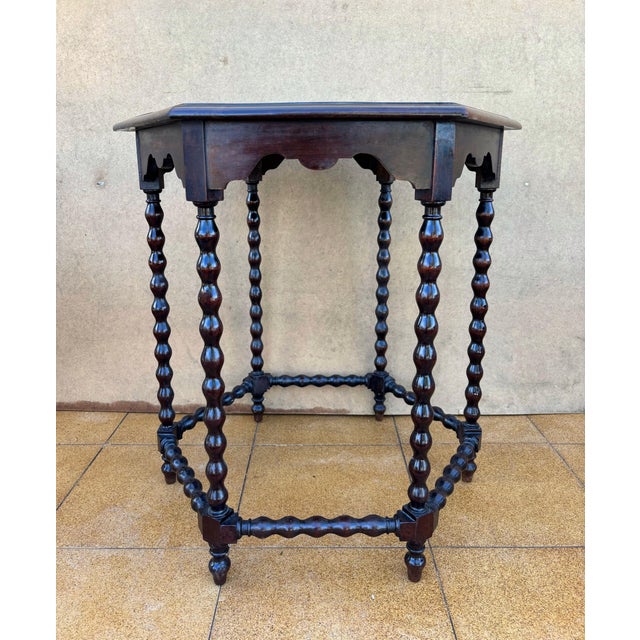 This refined Spanish side table dates from the early 20th century and reflects the Baroque Revival tradition that was...