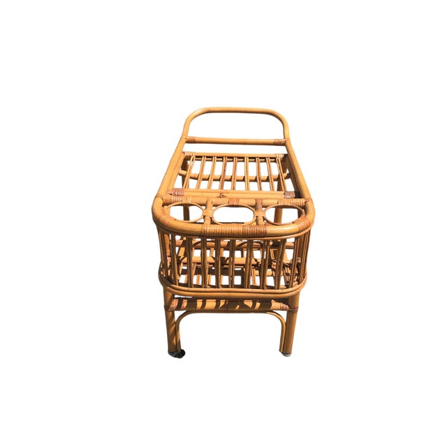 Vintage Rattan Bar Cart. Two tiered construction with bottle holders on the shelf. In very good vintage condition with no...