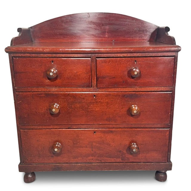 A sweet Victorian English country chest of drawers with lovely details including original wooden drawer pulls and round...