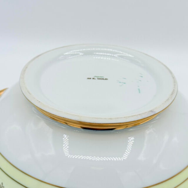 Take home this traditional lidded serving dish in ivory porcelain with ornate 22K gold detailing, marked Japan. The form...