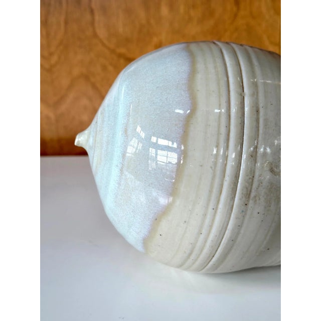 A ceramic closed-form pot with rattle by Japanese American artist Toshiko Takaezu (American, 1922 - 2011). The story: In...