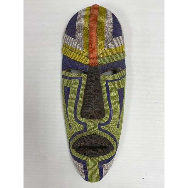 Design Plus Gallery presents a Handcrafted African Glass Beaded Carved Wood Mask. The carved wood form is adorned with...