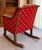 Vintage Traditional Wooden Rocking Chair with Red & Gold Star Upholstery A charming vintage wooden rocking chair featuring...