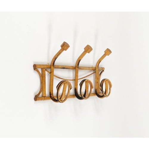 Midcentury beautiful wall coat rack in bamboo and rattan The piece was produced in Italy in 1960s and features a structure...