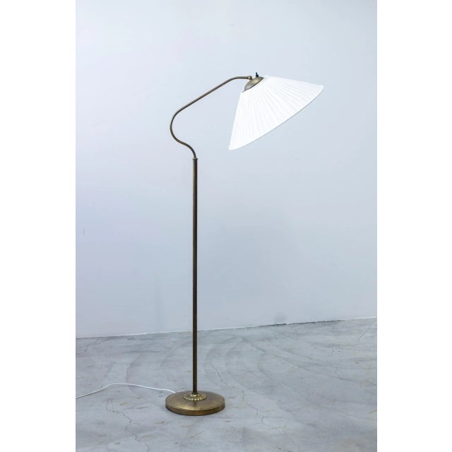 Floor lamp designed by bertil brisborg. Produced by nordiska kompaniet during the 1940-50s. Made from brass with a large...