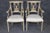 This elegant set of four Neoclassical painted side chairs is a remarkable example of refined European craftsmanship,...