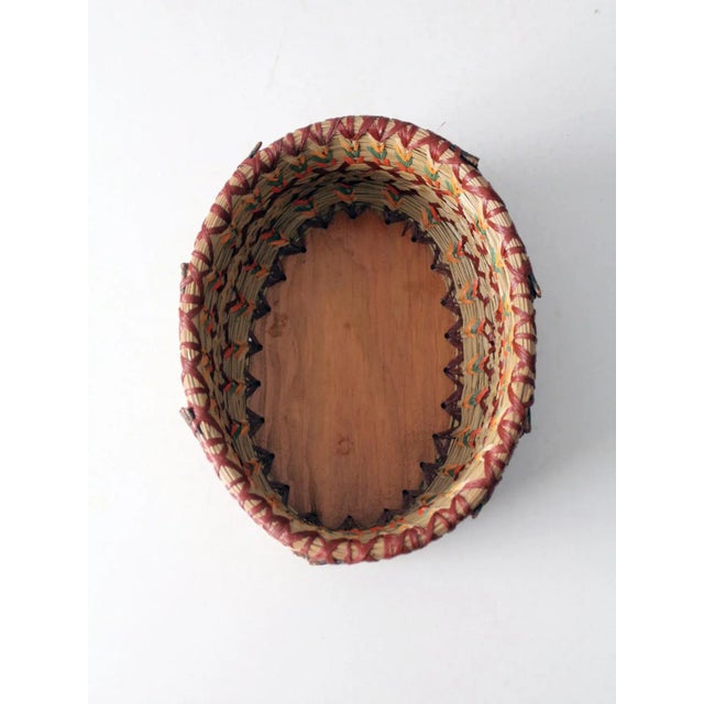 This is a vintage woven basket bowl. The decorative bowl features a stitch bound reed grass weave. Rich green, orange, and...