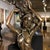 A cast bronze effigy of a mythological mermaid. It is signed "Harriet", near the bottom of the figurine, in a replica of...