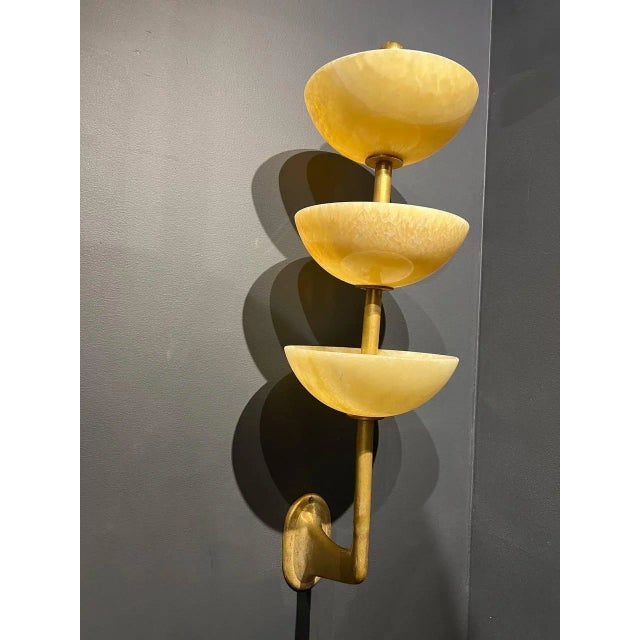 A pair of circa 1940’s 3 tiers alabaster sconces with interior lights