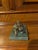 Lost wax cast bronze statue depicting a recumbent boy holding a bird mounted on a green rectangular marble base. Would...