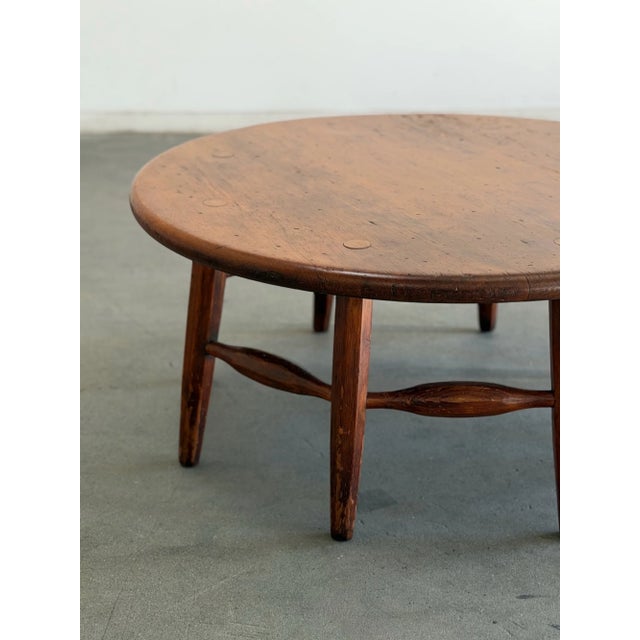 W39.5 D39.5 H18 A vintage Monterey style coffee table featuring a round wooden top, sculptural legs, and distinctive...