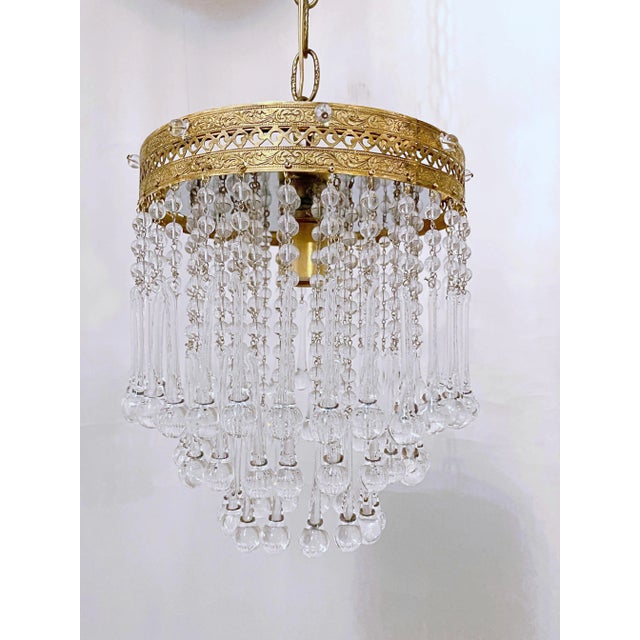 This is an Italian brass rim chandelier dressed with octagon chain and Strauss plug cut crystals drops. It has 1 Edison...