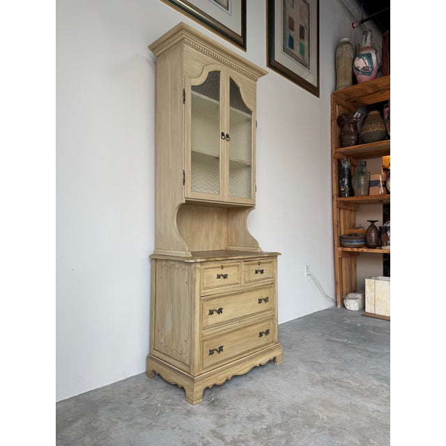 Charming antique French Country style cabinet featuring a classic two-piece hutch design with beautiful timeworn character...