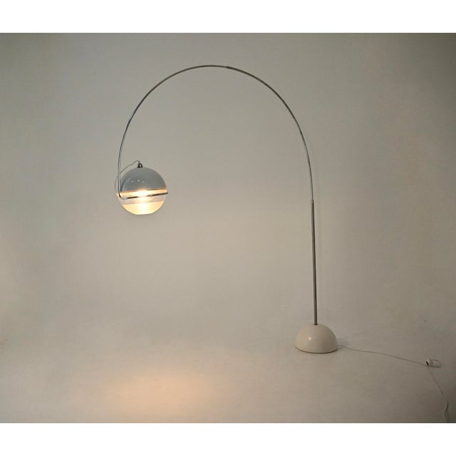 Plastic and metal floor lamp designed by Fabio Lenci for Guzzini. The globe can be oriented in any direction. Wear...